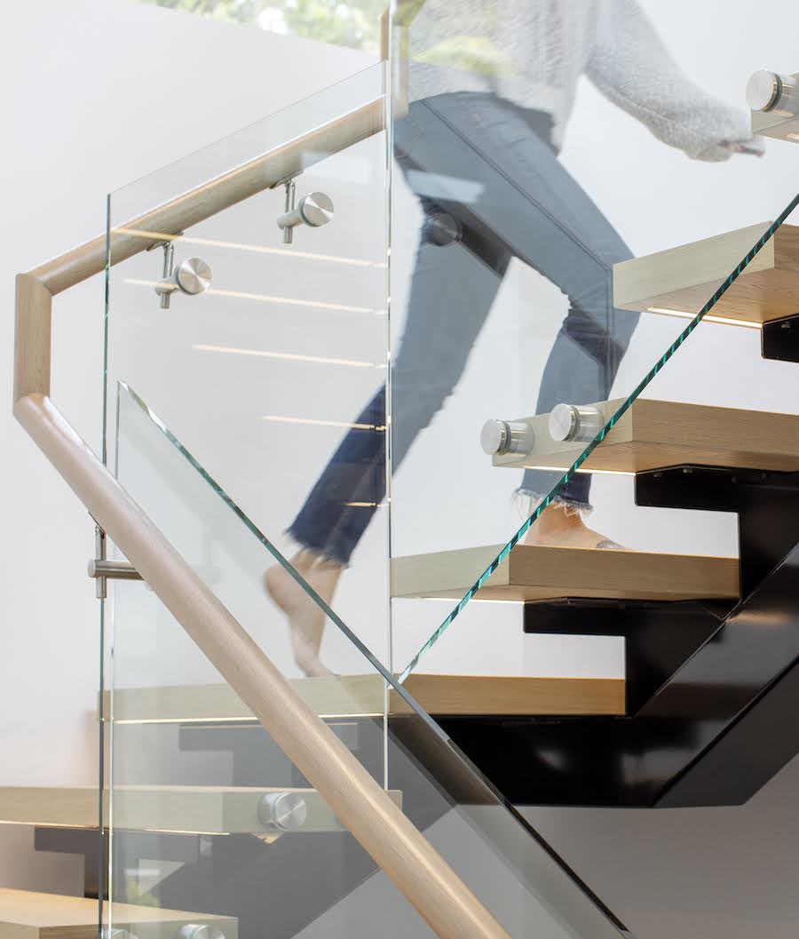 Duchess modern floating stairs with woman walking