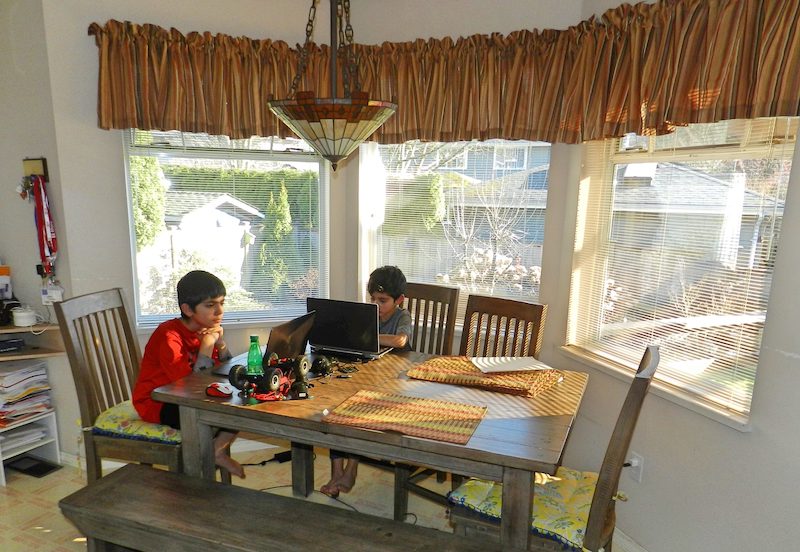 Kids playing in a breakfast nook before a renovation