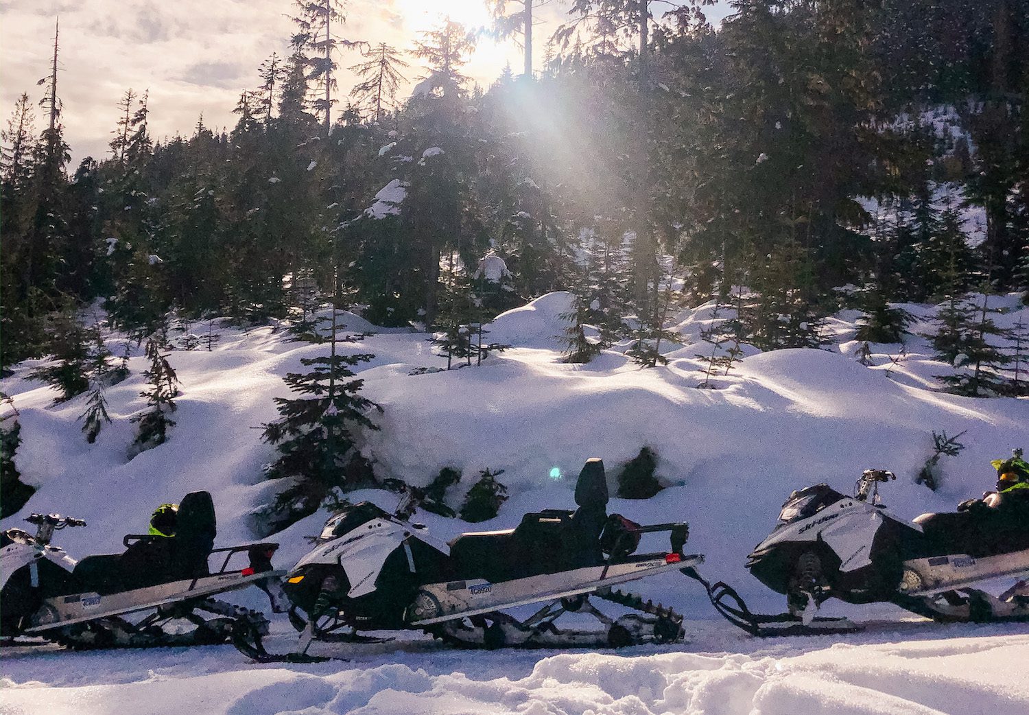 snowmobiles sitting in the sun in Whistler