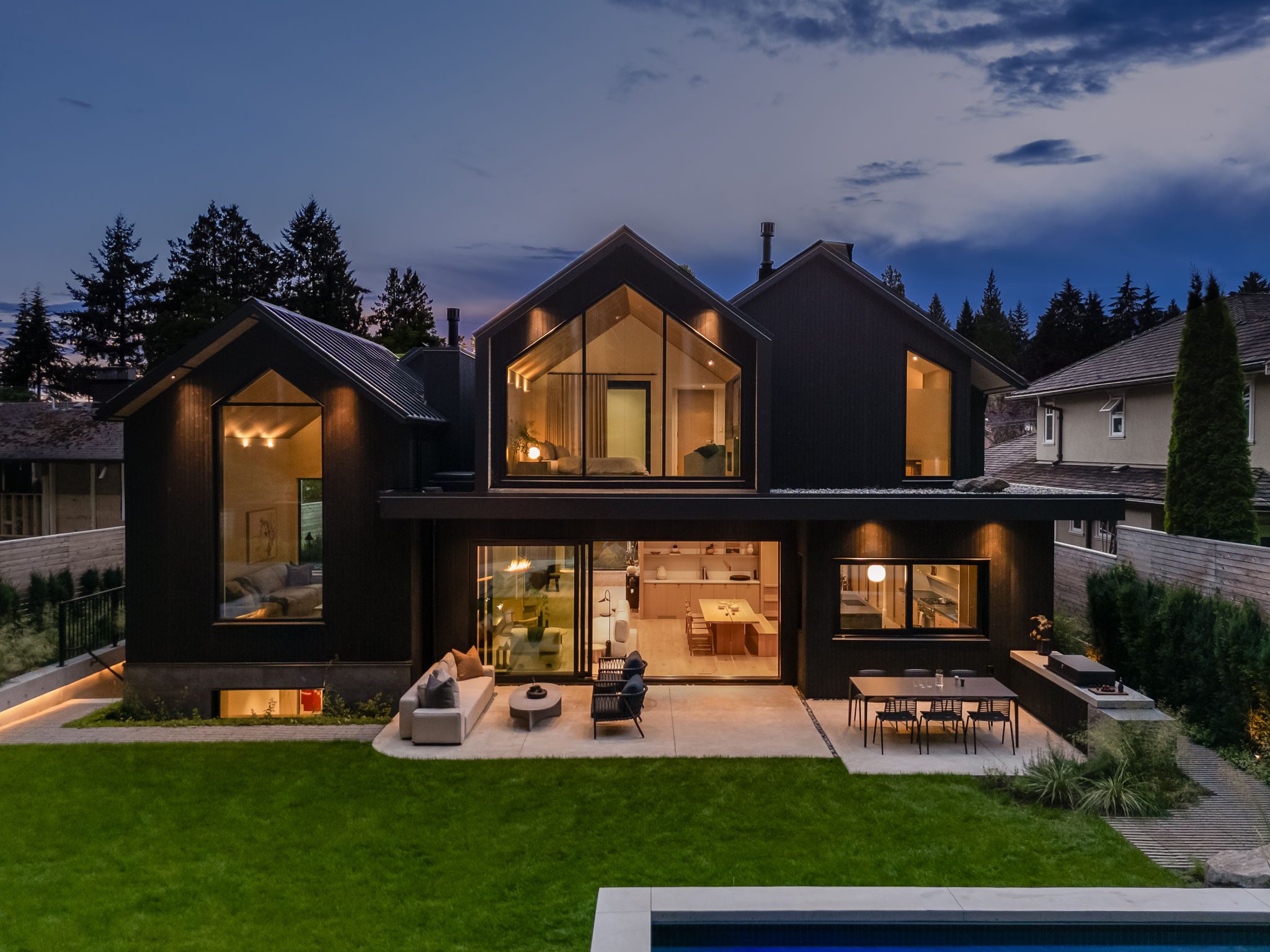 Japandia custom Japandi-style home in Edgemont, North Vancouver built by Hasler Homes - back exterior at dusk
