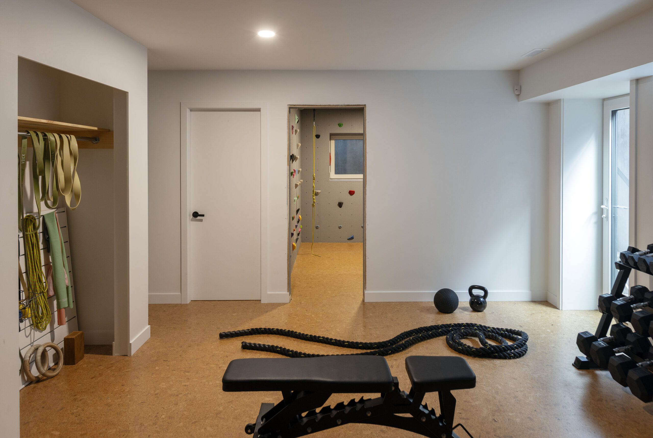 At-home gym inside Valleyhouse custom home in North Vancouver, with additional custom home features like a rock climbing wall