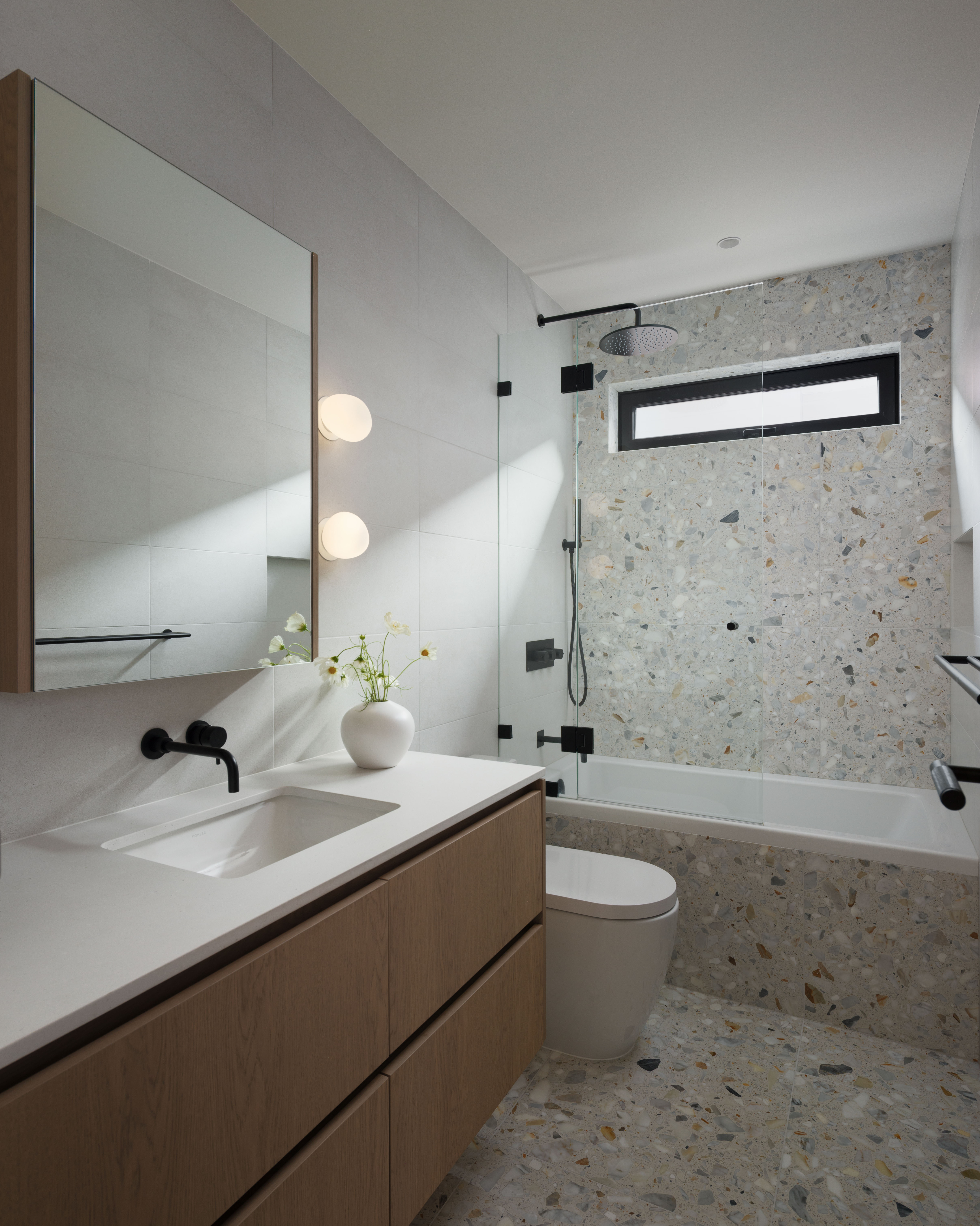 Fala custom home bathroom with wood vanity and glass-enclosed shower