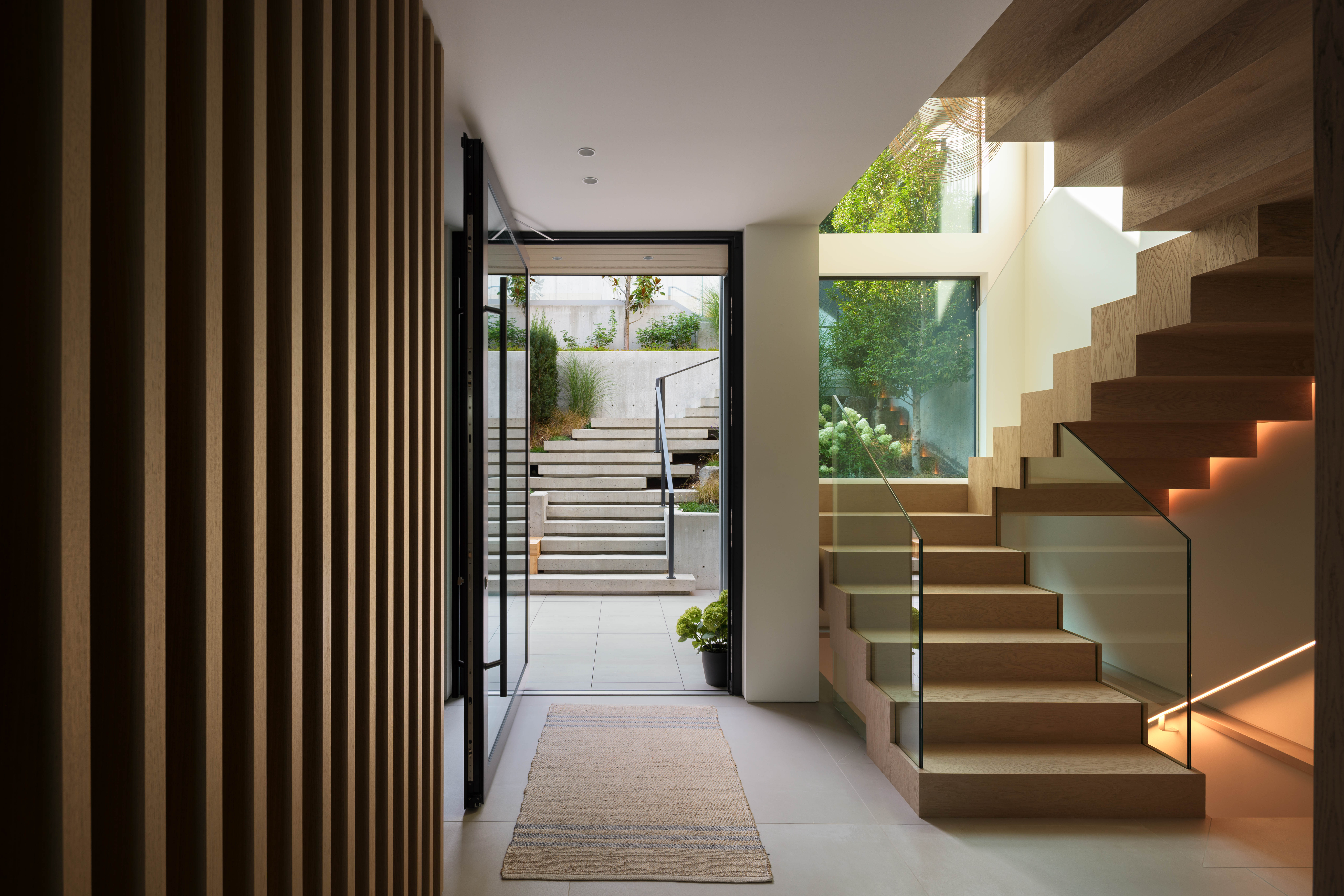 Fala custom home entrance with floating oak staircase