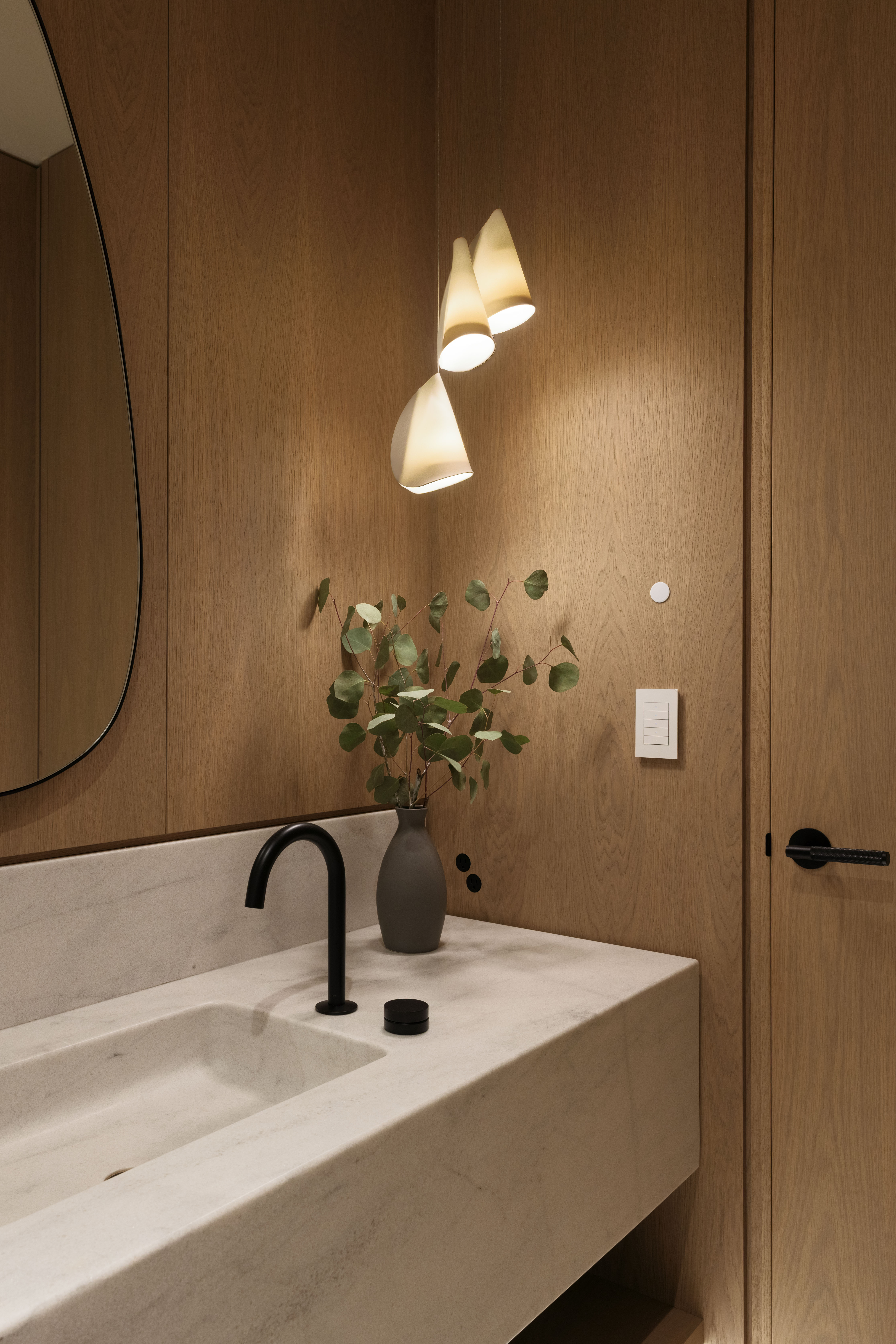 Fala powder room with stone vanity and wood walls